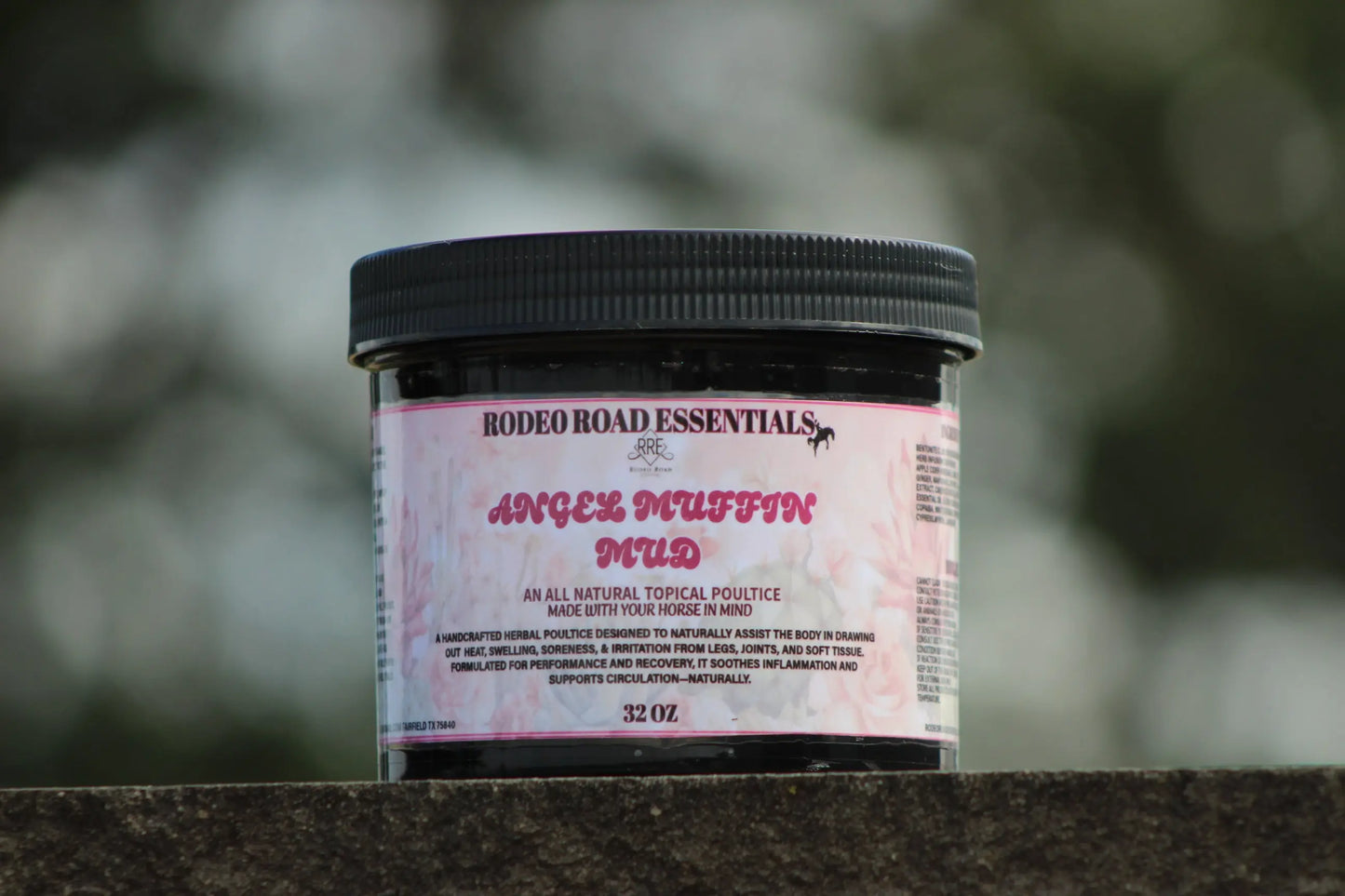 Focused shot of 32 oz jar of Angel Muffin Mud against a blurred background, highlighting its use in horse recovery.