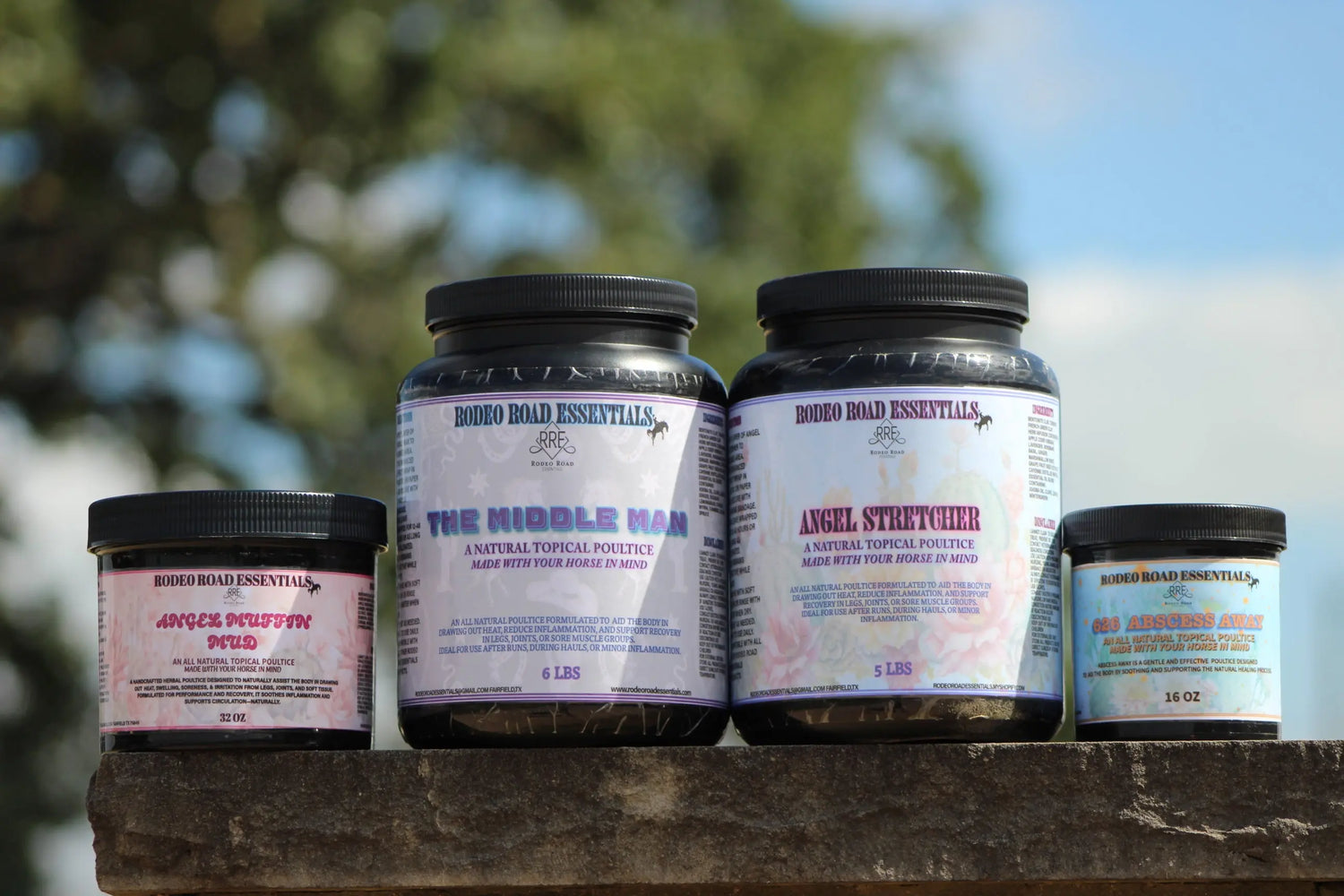 Rodeo Road Essentials Recovery Poultices collection showcased outdoors, featuring various poultices for equine care, including The Middle Man, Angel Stretcher, and 626 Abscess Away Herbal Poultice. Perfect for soft tissue recovery and pain management.