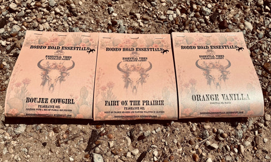 Rodeo Road Essentials Car or Trailer Sachet featuring three distinct scents: Boujee Cowgirl, Fairy on the Prairie, and Orange Vanilla, displayed against a rustic gravel background.