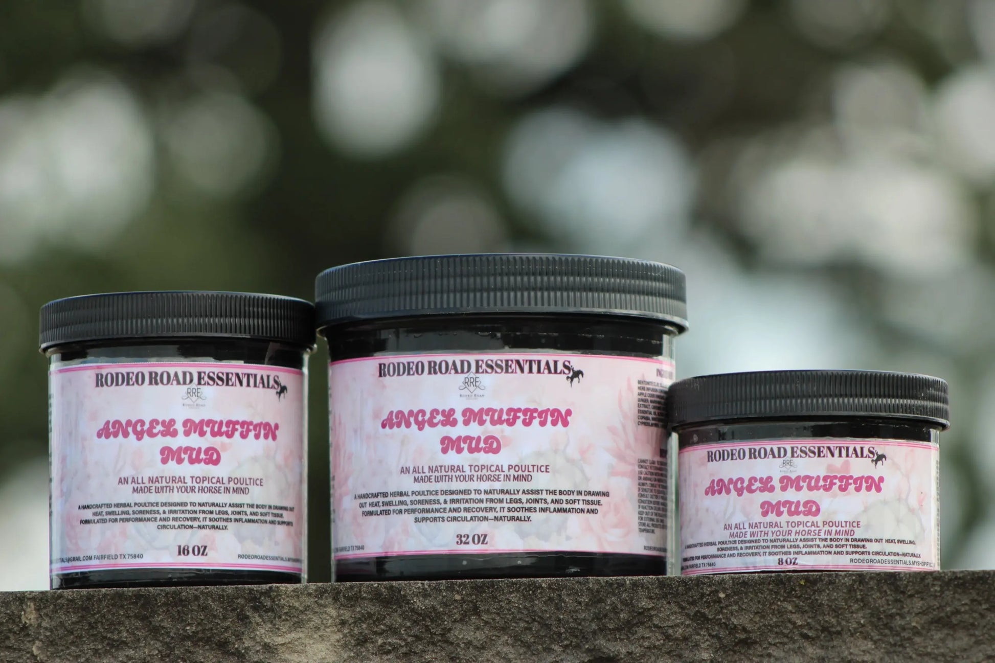 Angel Muffin Mud – All-natural topical poultice jars in various sizes displayed outdoors, ideal for recovery of sore legs and joints.