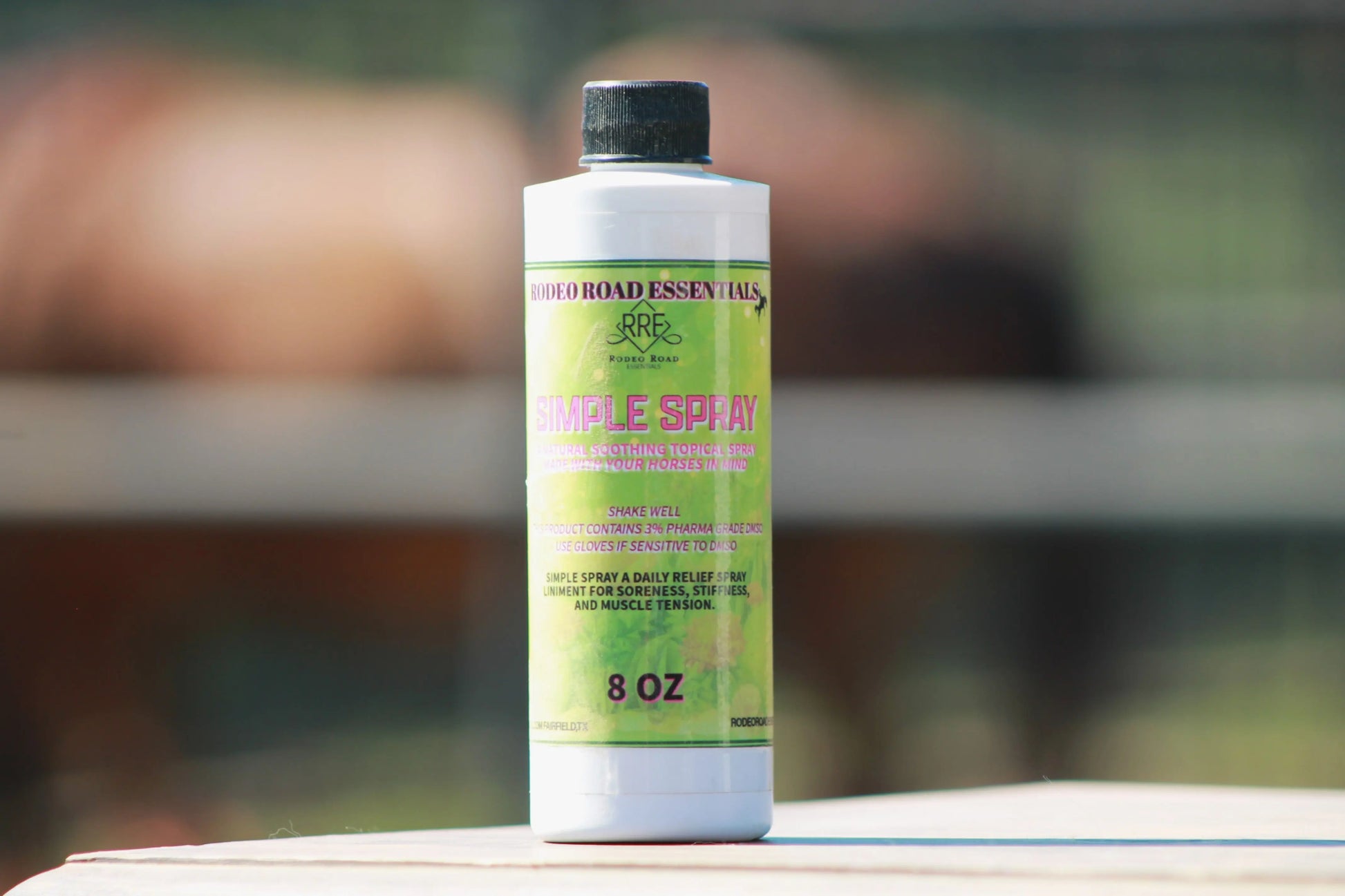 Rodeo Road Essentials Simple Spray 8 oz bottle in natural lighting, perfect for promoting the Everyday Herbal Comfort Spray for horses.